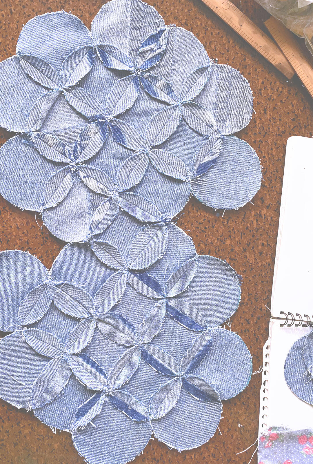 GENIE: THE WEAVER AND THE SPIRIT Reversible garments and bags constructed from denim and floral textiles through geometric patchwork and repairable design.