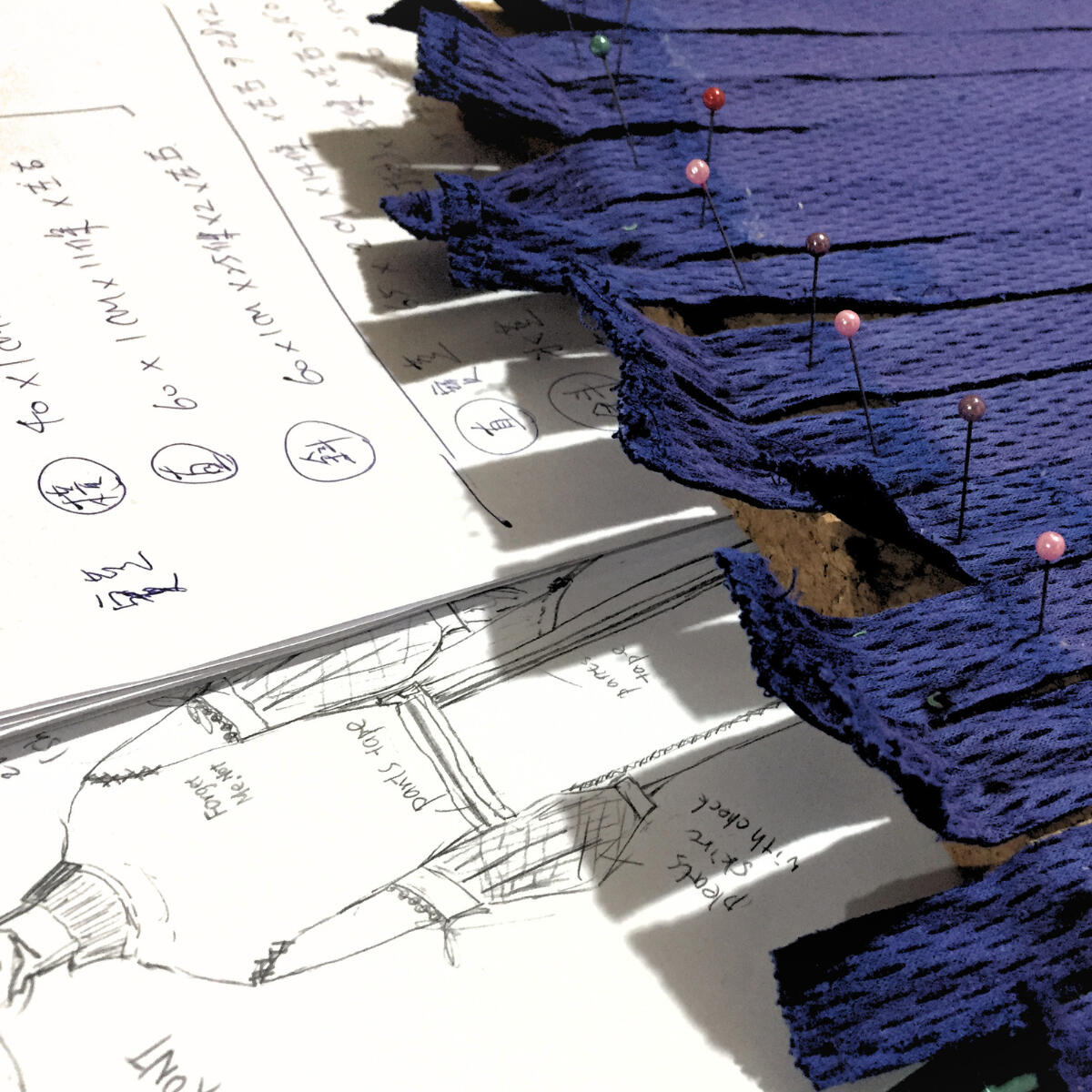 WHO'S UNIFORM Close view of woven textile composed from reclaimed school uniform materials.