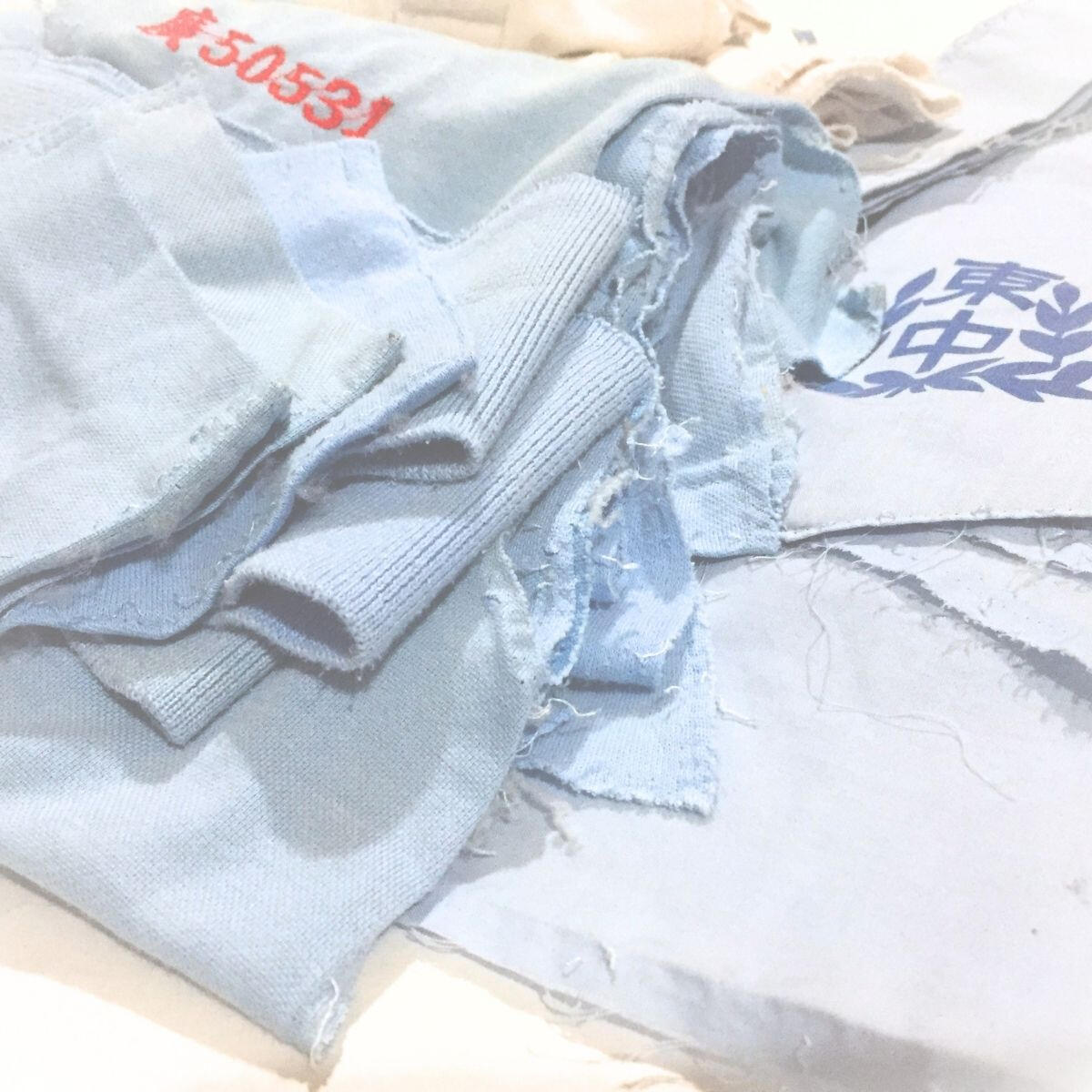 Who's Uniform Garment Deconstruction School badges, student numbers, and fabric panels from deconstructed uniforms.