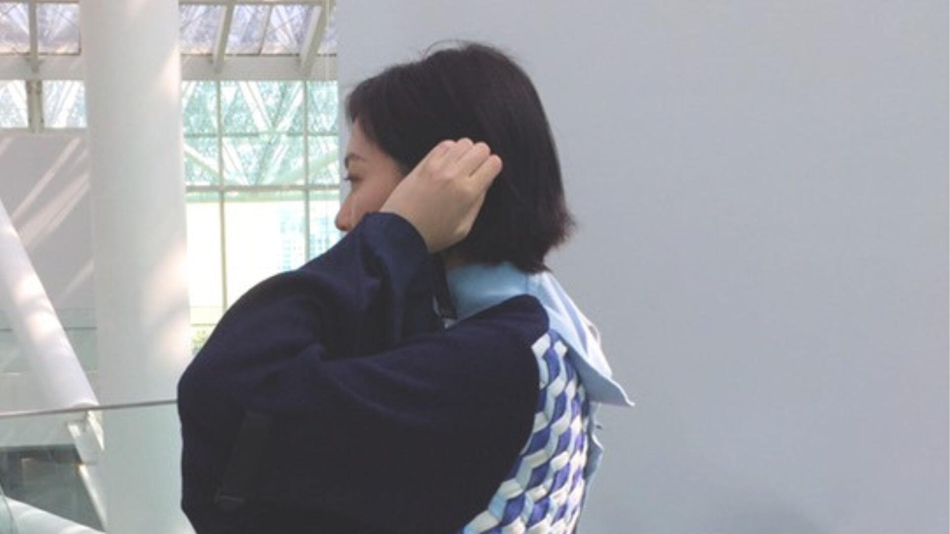 Who's Uniform Sideview Person wearing a reconstructed uniform garment viewed from the side.
