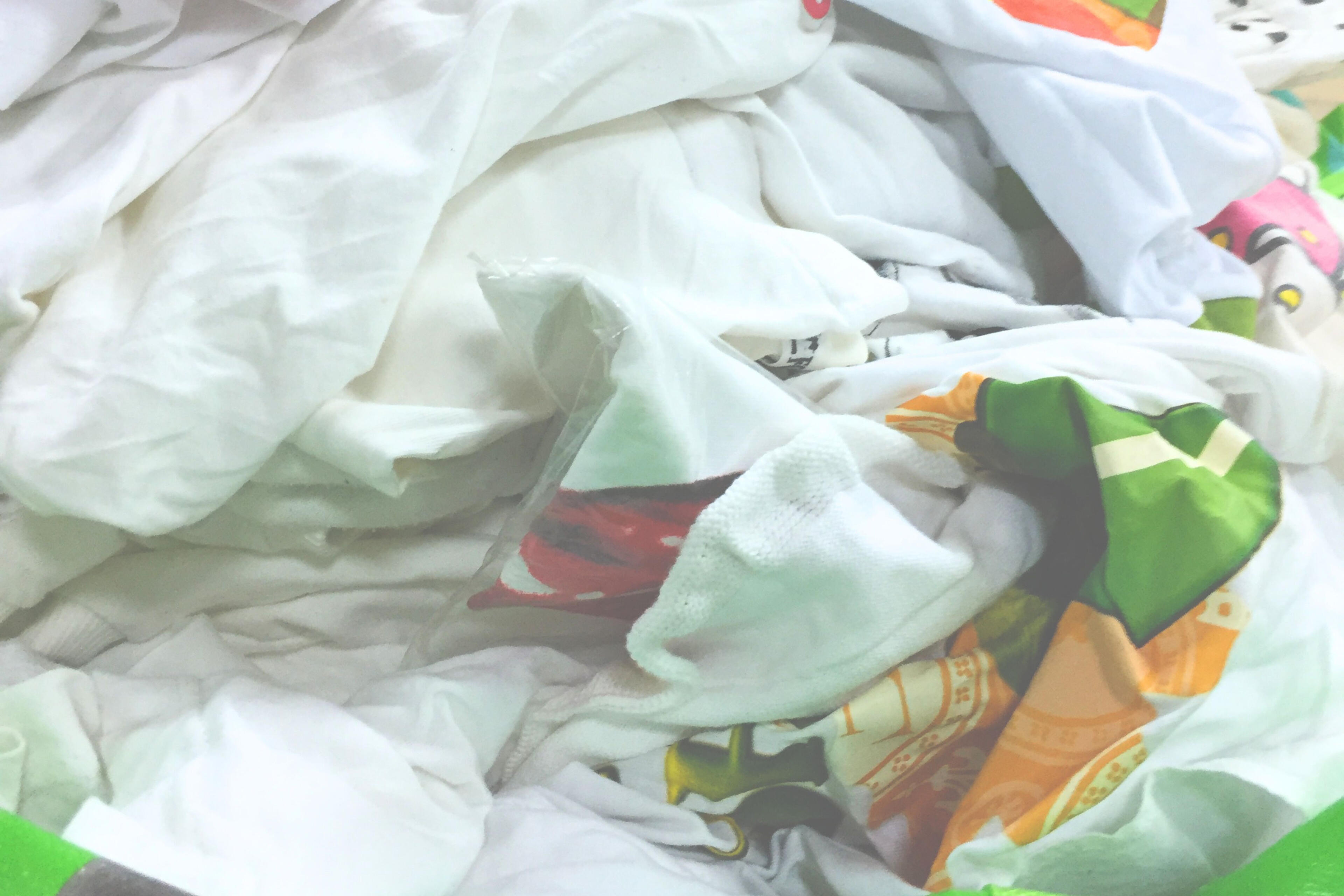White T-shirt collection for recycling experiment. collected white T-shirts sorted in studio for textile recycling research